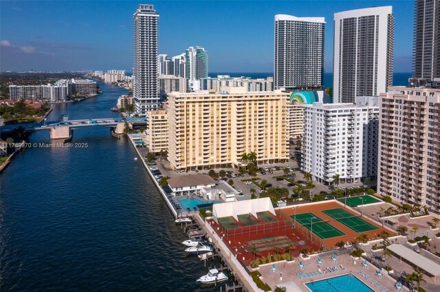 drone / aerial view with a city view and a water view