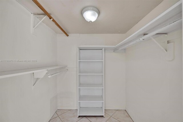 spacious closet with light tile patterned floors