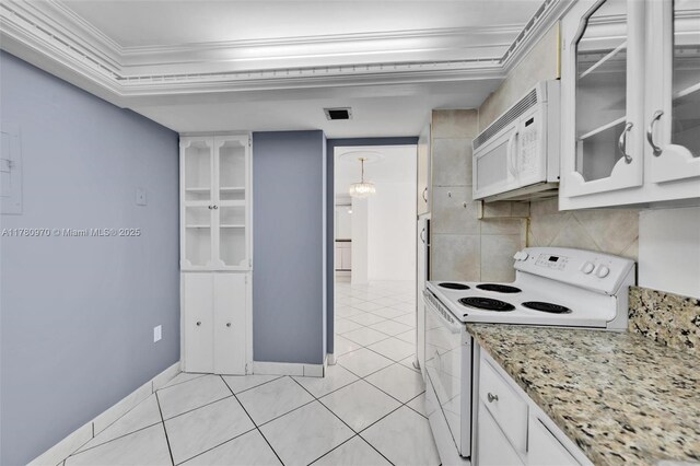 kitchen with crown molding, light tile patterned floors, white appliances, white cabinetry, and backsplash
