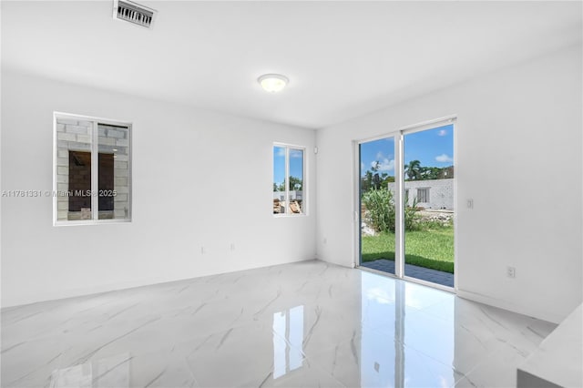 empty room featuring visible vents and marble finish floor