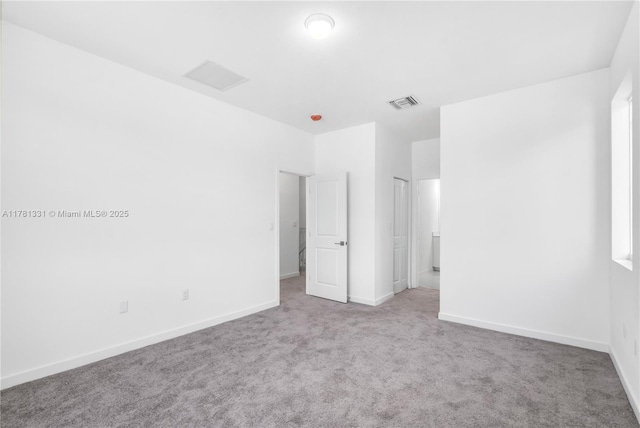 unfurnished bedroom featuring visible vents, baseboards, and carpet