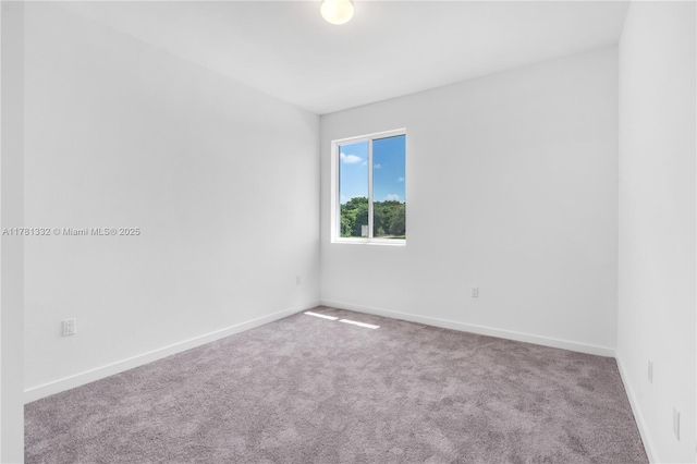 carpeted empty room with baseboards