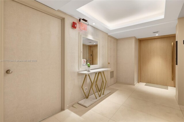 2800 E Sunrise Blvd Unit 14B, Fort Lauderdale, FL 33304 - hall featuring a raised ceiling, light tile patterned flooring, and visible vents