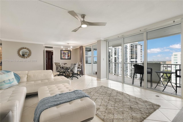 living area featuring ornamental molding, visible vents, tile patterned flooring, and ceiling fan