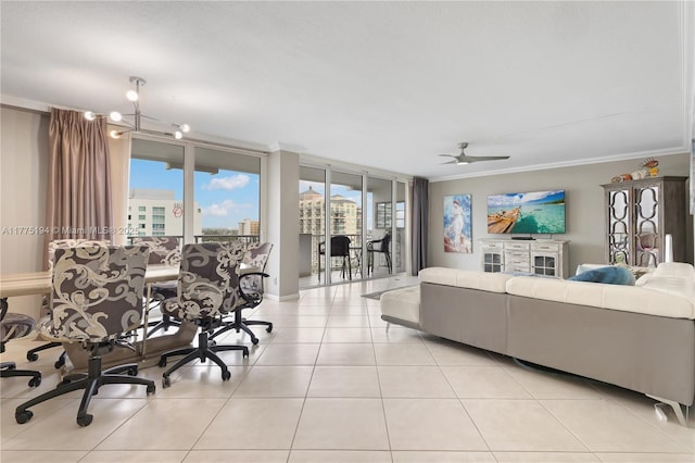 living area with light tile patterned floors, ornamental molding, a ceiling fan, and plenty of natural light