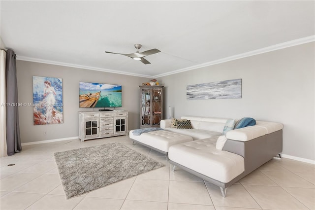 living area with crown molding, light tile patterned flooring, baseboards, and a ceiling fan