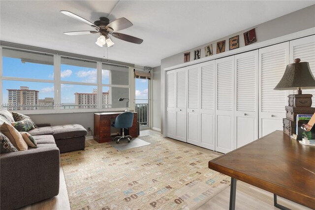 2800 E Sunrise Blvd Unit 14B, Fort Lauderdale, FL 33304 - office area featuring baseboards, a view of city, ceiling fan, and wood finished floors