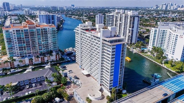 drone / aerial view featuring a water view and a view of city