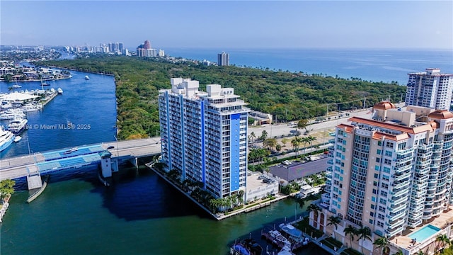 birds eye view of property featuring a water view and a view of city