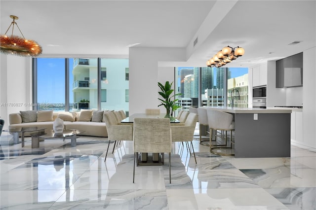 788 NE 23rd St Unit 1001, Miami, FL 33137 - dining room with healthy amount of natural light and light marble finish flooring
