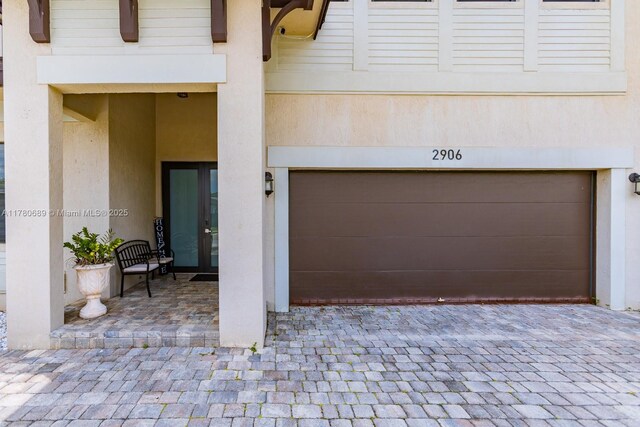 garage featuring driveway and french doors
