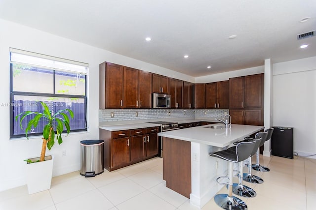 kitchen featuring visible vents, light countertops, backsplash, and appliances with stainless steel finishes