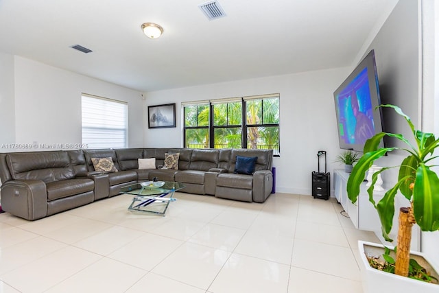 living room featuring visible vents, baseboards, and light tile patterned floors