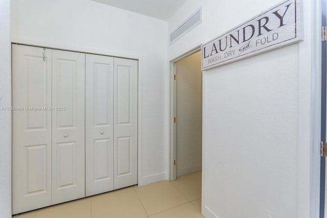 interior space featuring visible vents, baseboards, a closet, and light tile patterned floors