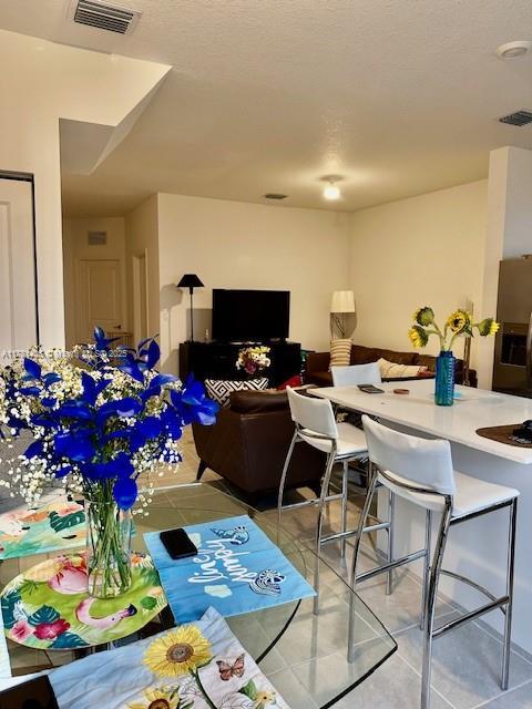dining area featuring tile patterned flooring and visible vents