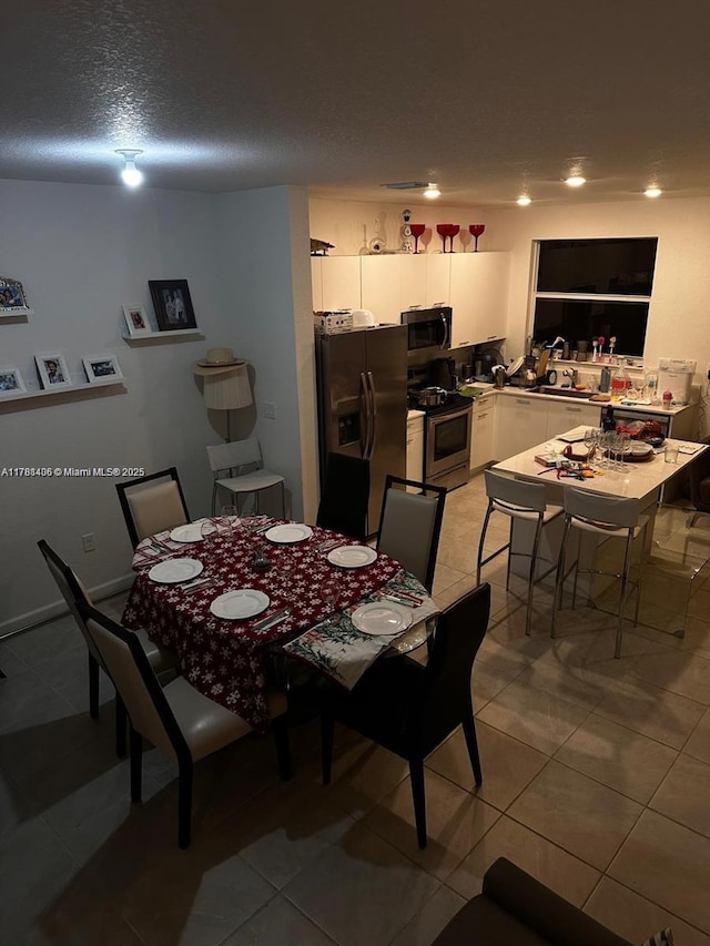 12220 NW 23rd Ct Unit 12220, Miami, FL 33167 - dining room with a textured ceiling and light tile patterned flooring