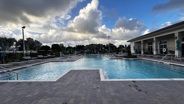 pool featuring a patio area and fence