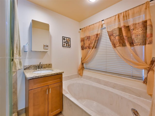 full bathroom with vanity and a garden tub