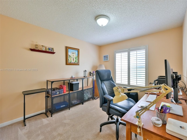 office with carpet floors, baseboards, and a textured ceiling