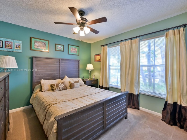 bedroom with carpet flooring, baseboards, and a textured ceiling