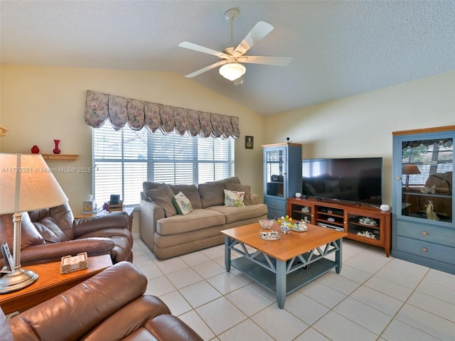 living room featuring a textured ceiling, light tile patterned floors, a ceiling fan, and lofted ceiling
