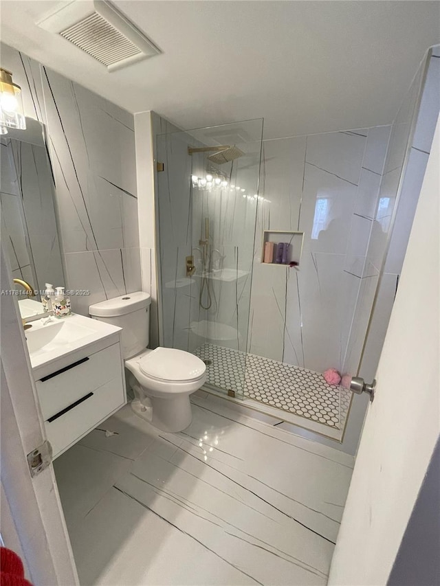 112 Royal Park Dr Unit 2G, Oakland Park, FL 33309 - bathroom with vanity, a marble finish shower, toilet, visible vents, and marble finish floor