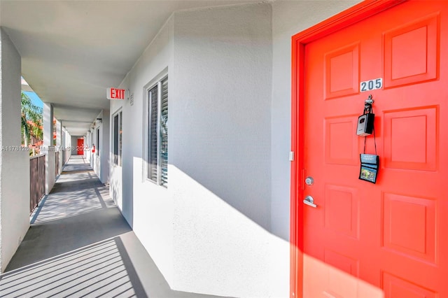 entrance to property with stucco siding