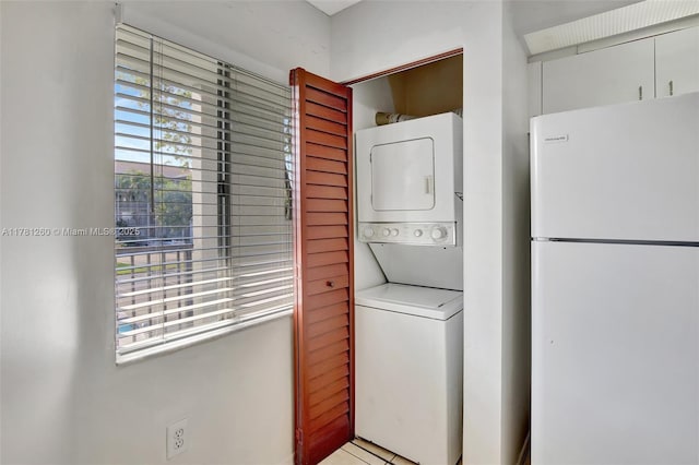 washroom with laundry area and stacked washer / drying machine