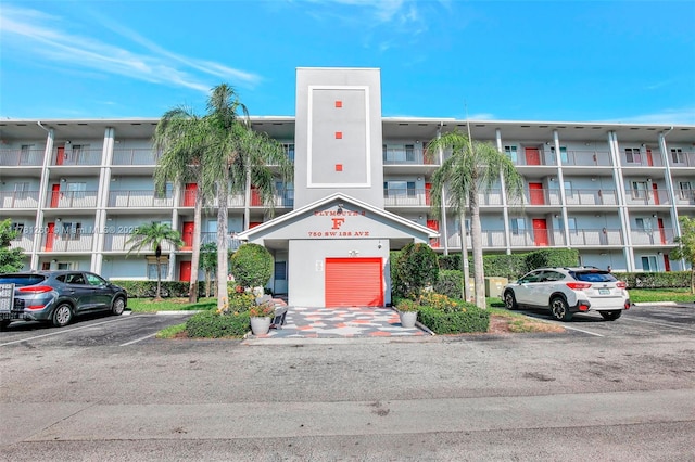 view of building exterior with uncovered parking