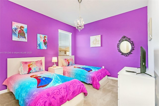 carpeted bedroom featuring baseboards and a chandelier