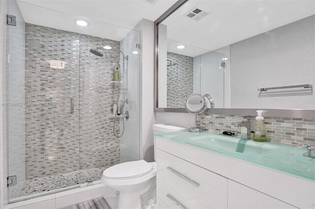 325 S Biscayne Blvd Unit 2519, Miami, FL 33131 - full bath featuring a shower stall, vanity, visible vents, toilet, and backsplash