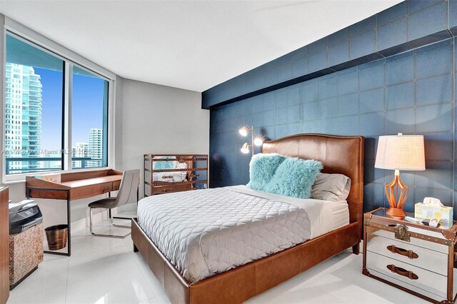 325 S Biscayne Blvd Unit 2519, Miami, FL 33131 - bedroom featuring tile patterned flooring, an accent wall, and a view of city