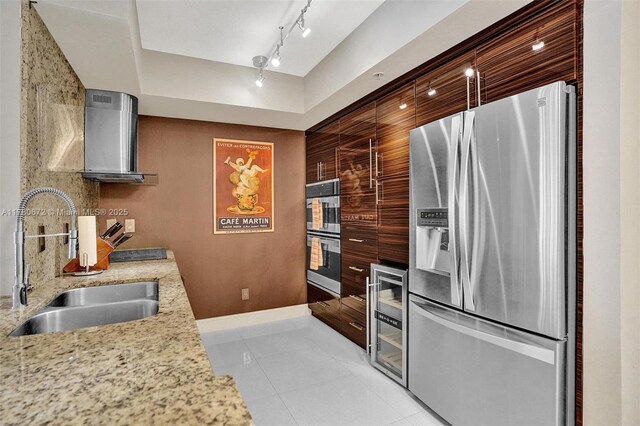 325 S Biscayne Blvd Unit 2519, Miami, FL 33131 - kitchen with appliances with stainless steel finishes, wall chimney range hood, light tile patterned flooring, wine cooler, and a sink