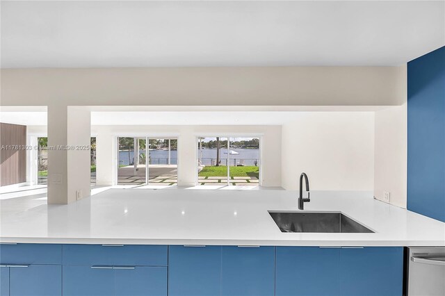 5020 SW 92nd Ave, Miami, FL 33165 - kitchen featuring a sink, light countertops, blue cabinetry, stainless steel dishwasher, and modern cabinets