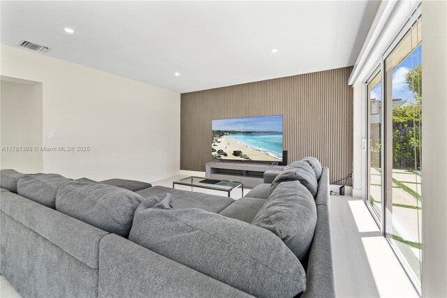 5020 SW 92nd Ave, Miami, FL 33165 - living room with an accent wall, recessed lighting, wood walls, and baseboards