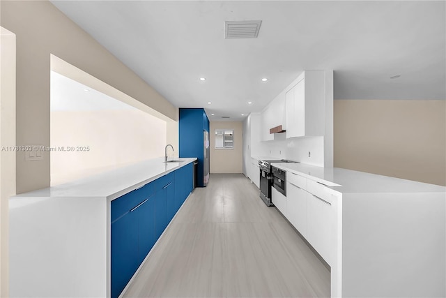 5020 SW 92nd Ave, Miami, FL 33165 - kitchen with stainless steel range with electric cooktop, modern cabinets, a peninsula, a sink, and recessed lighting