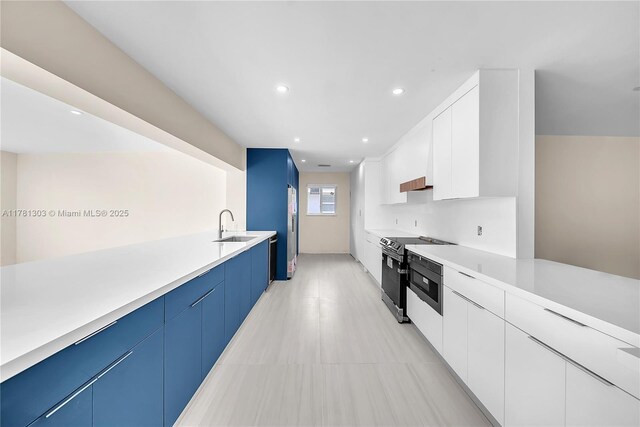 5020 SW 92nd Ave, Miami, FL 33165 - kitchen featuring black / electric stove, modern cabinets, light countertops, recessed lighting, and white cabinets