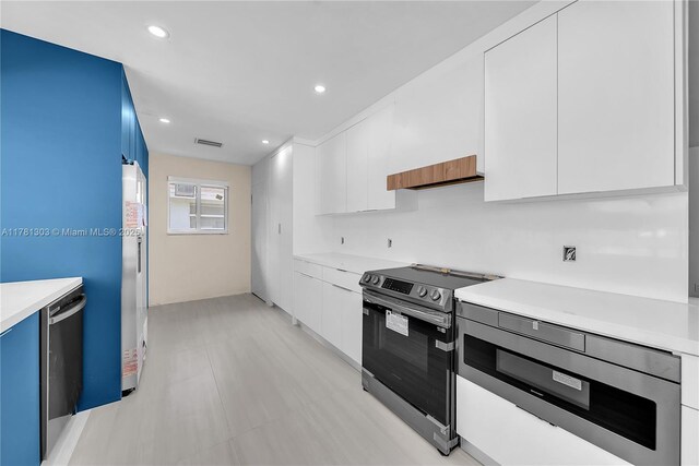 5020 SW 92nd Ave, Miami, FL 33165 - kitchen with appliances with stainless steel finishes, modern cabinets, light countertops, white cabinets, and recessed lighting