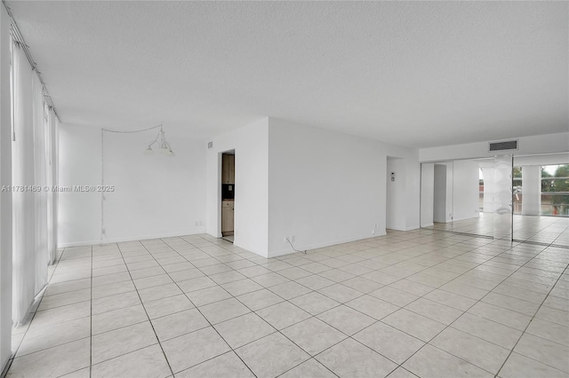 2001 Atlantic Shores Blvd Unit 220, Hallandale Beach, FL 33009 - empty room with visible vents, light tile patterned floors, and a textured ceiling