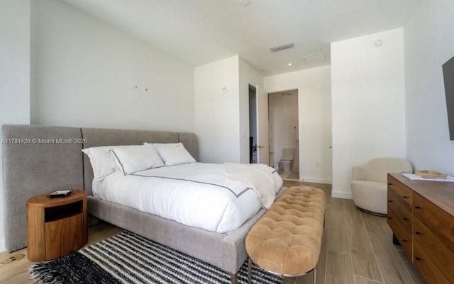 bedroom featuring light wood finished floors, baseboards, and visible vents
