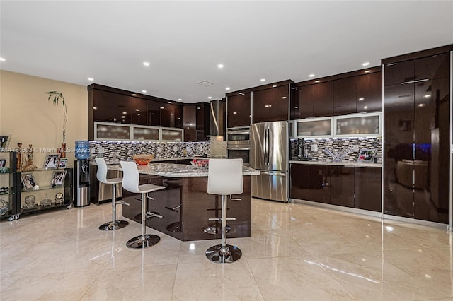 1094 Redwood St ., Unit Hollywood, FL 33019 - kitchen featuring marble finish floor, a breakfast bar, modern cabinets, and appliances with stainless steel finishes