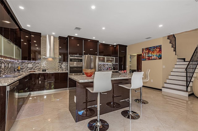 1094 Redwood St ., Unit Hollywood, FL 33019 - kitchen featuring a kitchen breakfast bar, wall chimney exhaust hood, modern cabinets, stainless steel appliances, and marble finish floor