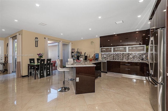 1094 Redwood St ., Unit Hollywood, FL 33019 - kitchen featuring a center island, a kitchen breakfast bar, modern cabinets, and freestanding refrigerator