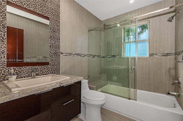 1094 Redwood St ., Unit Hollywood, FL 33019 - full bathroom featuring combined bath / shower with glass door, tile walls, toilet, vanity, and decorative backsplash