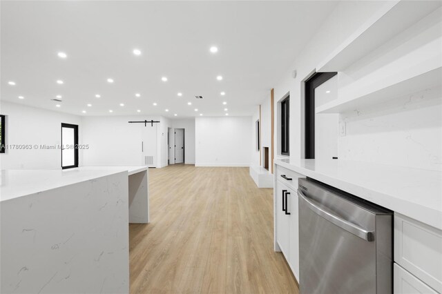 corridor with visible vents, baseboards, recessed lighting, and light wood finished floors