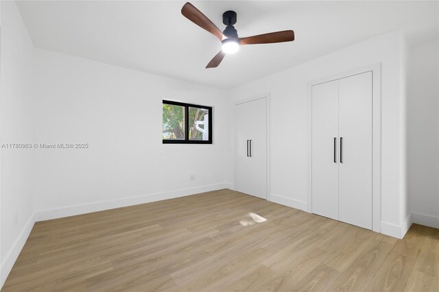 unfurnished bedroom with light wood finished floors, baseboards, and a ceiling fan