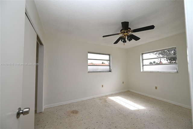 unfurnished bedroom with a ceiling fan, baseboards, and a closet