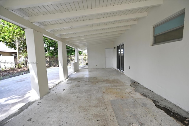 view of patio with fence and a carport