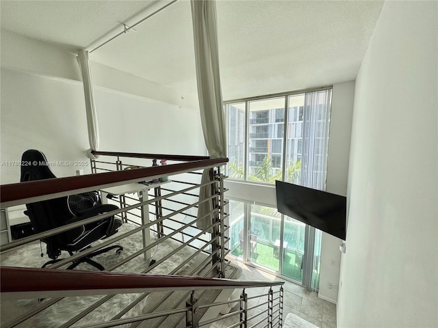 staircase with a textured ceiling