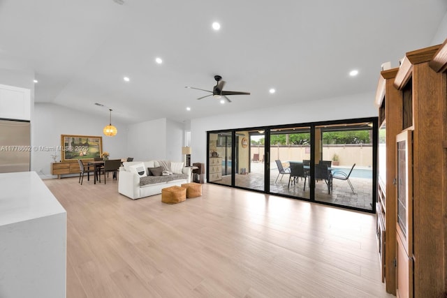 living area with recessed lighting, light wood-style floors, ceiling fan, and vaulted ceiling